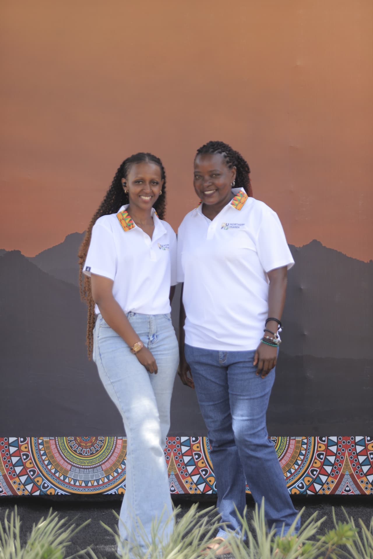 Two festival team members posing before the launch backdrop